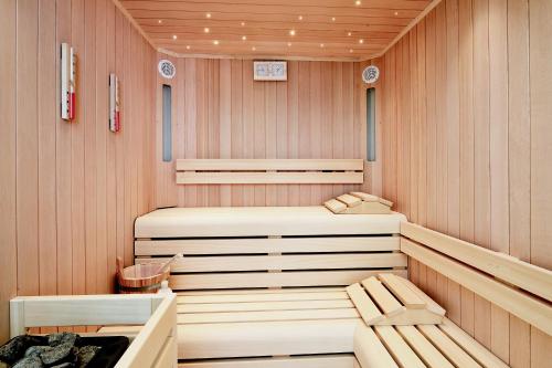 a sauna with two chairs in a wooden room at Grand Hotel & Riviera in Lido di Camaiore