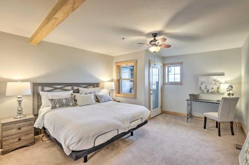a bedroom with a bed with a ceiling fan and a desk at Dillon Condo on Main Street Walk to Waterfront! in Dillon