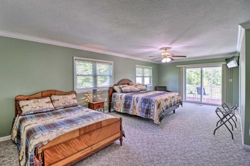 a bedroom with two beds and a ceiling fan at Robinson Roost Retreat Less Than 2 Mi to Norfork Lake in Mountain Home