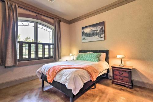 a bedroom with a bed and a large window at Flawless Durango Home with Theater and Pool Table in Durango