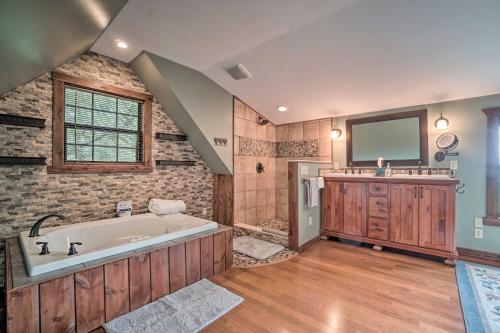 a large bathroom with a tub and a sink at Yellow Mountain Blairsville Cabin with Scenic Deck in Hood