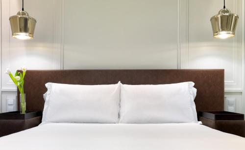 Ένα ή περισσότερα κρεβάτια σε δωμάτιο στο Boutique Hotel H10 Montcada