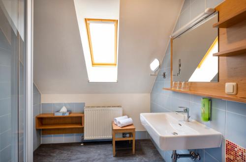 a bathroom with a sink and a mirror at JUFA Hotel Judenburg - Self Check-In in Judenburg