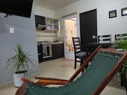 a living room with a hammock and a kitchen at Casa de vacaciones in Veracruz