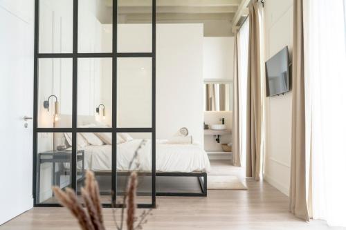 a bedroom with a bed and a sliding glass door at Suites Alfonso X in Jerez de la Frontera