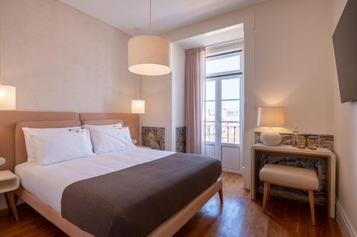 Säng eller sängar i ett rum på Memoria Lisboa FLH Hotels