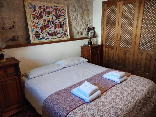 um quarto com uma cama com duas toalhas em La Antigua casa del cartero em Roda de Eresma