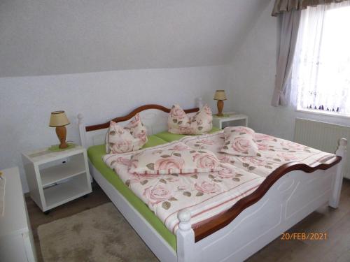 - une chambre avec un lit doté de draps et d'oreillers roses dans l'établissement Rewo-II-Rabe-Reusenweg-3-18581-Lauterbach, à Lauterbach