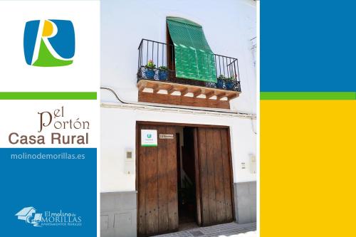 a building with a wooden door and a balcony at Casa Rural El Portón de Galera in Galera