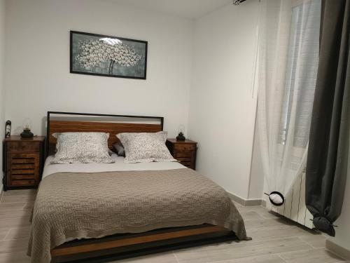 a bedroom with a bed in a white room at Beauregard, votre maison en Provence in Orgon