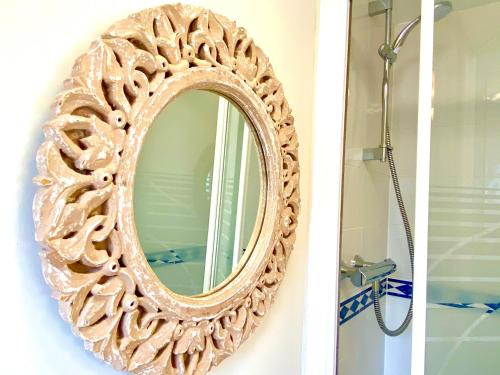 a mirror hanging on a wall in a bathroom at Aylesbury Contractor & Staycation Home in Aylesbury