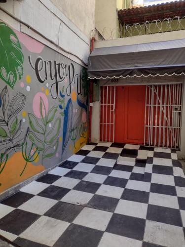 a building with a checkered floor and a red door at Ipanema Club Hostel in Rio de Janeiro