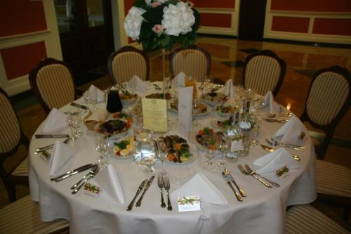 a white table with plates of food on it at Hotel Supraśl in Supraśl