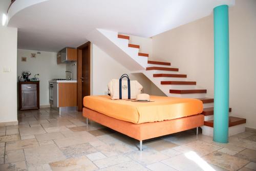 a bedroom with a bed and a staircase at Monteforte Resort in Ugento