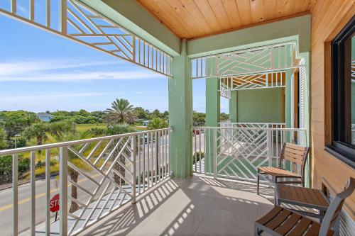 a balcony with two chairs and a window at Holiday Inn Express St. Augustine - Vilano Beach by IHG in Saint Augustine