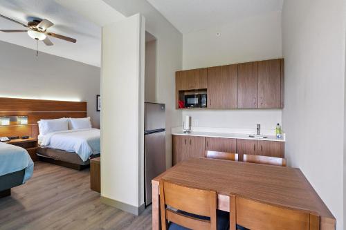 a kitchen with a bed and a refrigerator at Holiday Inn Express St. Augustine - Vilano Beach, an IHG Hotel in Saint Augustine