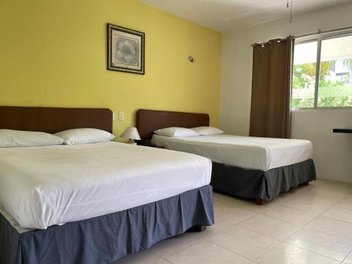 Ένα ή περισσότερα κρεβάτια σε δωμάτιο στο Hotel Villa Escondida Campeche