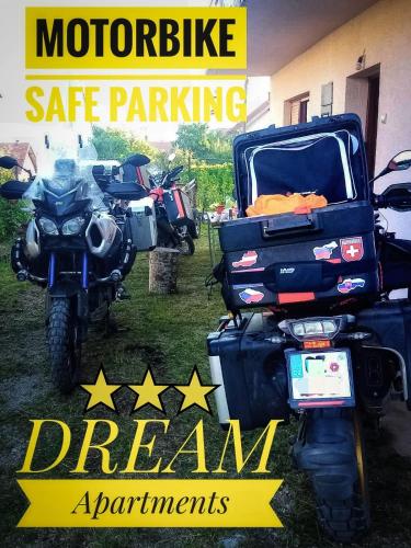 a motorcycle parked in front of a garage with the words motorcycle safe parking dream apartments at Dream in Drvar