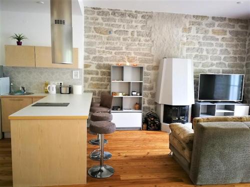 a kitchen and living room with a counter and a couch at Perfect stay in Old Town with Parking in Tallinn