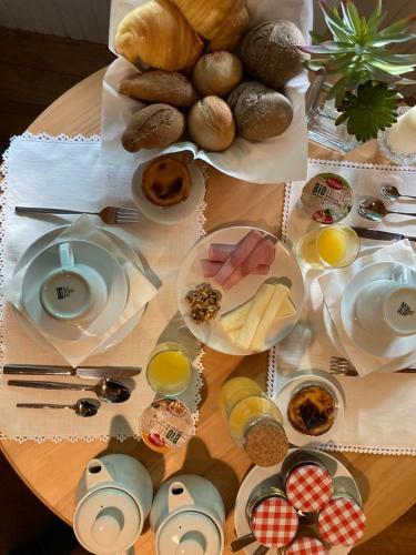 a table with breakfast foods on a table at Quinta do Pinheiro in Guimarães