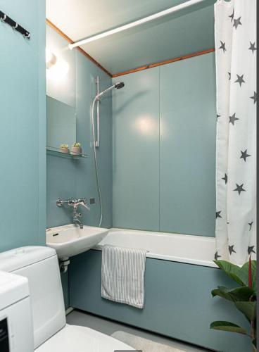 a bathroom with a shower and a toilet and a sink at Scandinavian Home 1BR Unbeatable Central Location 26 in Helsinki
