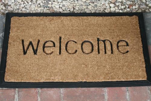 a sign with the word welcome on a sidewalk at Ayrs and Graces - Luxury Bed and Breakfast in Ayr