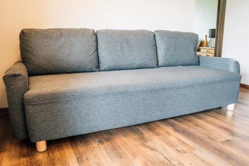 a blue couch sitting in a living room at Apartamenty Madzia in Wisła