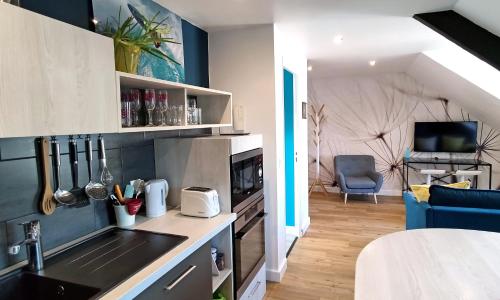 a kitchen with a sink and a counter top at LE REFLET MERVILLE - Central & chic - AufildeLorient in Lorient