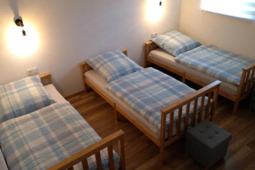 um quarto com três camas num quarto em at Kessler Living and Sleeping em Kirchberg an der Jagst