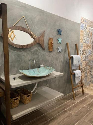 a bathroom with a sink and a mirror on a wall at FLATS MACAPÁ MEU AMOR 6 in Luis Correia