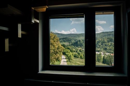 a window with a view of a mountain view at Apartamenty Madzia in Wisła