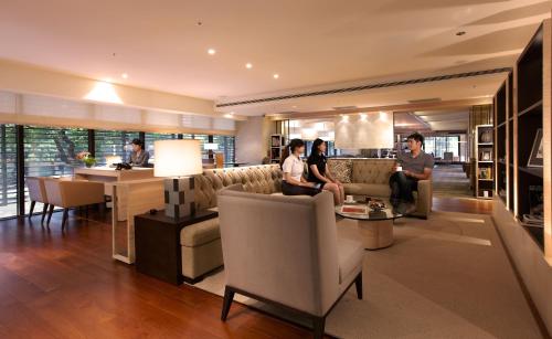 a group of people sitting in a living room at Hotel COZZI Minsheng Taipei in Taipei