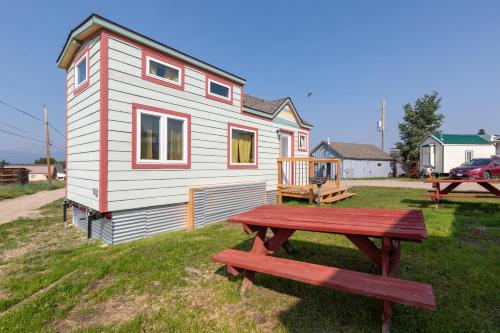 a tiny house with a picnic table in front of it at Tiny House Leadville Colorado in Leadville