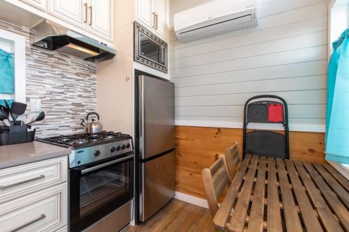 a kitchen with a stove and a refrigerator at Tiny House Leadville Colorado in Leadville