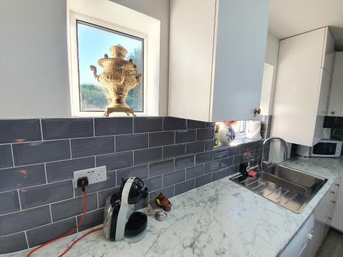 a kitchen with a sink and a window at St Georges house, Premium 3 bed Home Slough, Legoland, Windsor in Slough