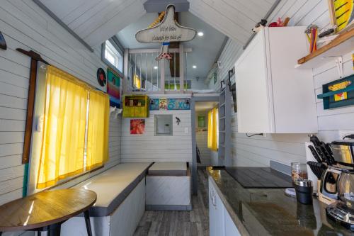 a kitchen in a tiny house with yellow curtains at Tiny House Leadville Colorado in Leadville