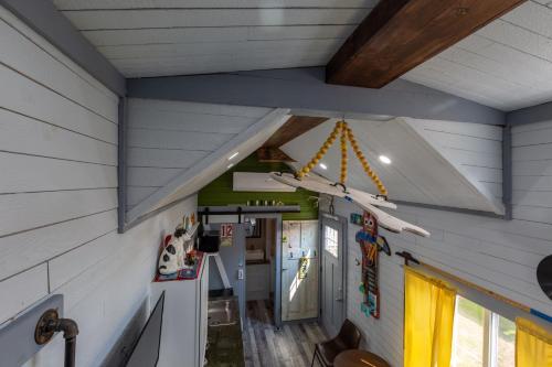 a room with a ceiling with a plane hanging from it at Tiny House Leadville Colorado in Leadville