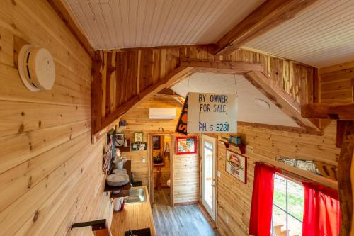 a cabin with wooden walls and a room with a sign at Tiny House Leadville Colorado in Leadville
