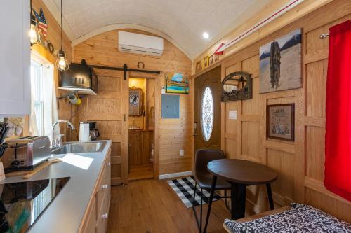 a kitchen and dining area of a tiny house at Tiny House Leadville Colorado in Leadville