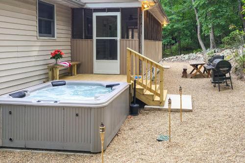 a hot tub sitting outside of a house at 17-Seat Theater, Hot Tub and Game Room Ideal Home! in Massanutten