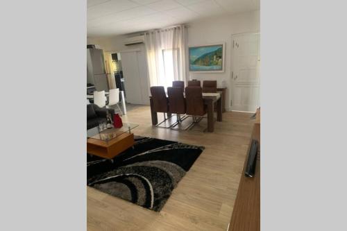 a living room with a table and a dining room at Para un descanso total in Sant Jaume dels Domenys