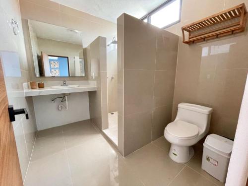 a bathroom with a toilet and a sink at Aldeazul by Andiani Travel in Cancún
