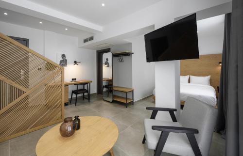 a hotel room with a bed and a flat screen tv at Pillow urban stay in Thessaloniki