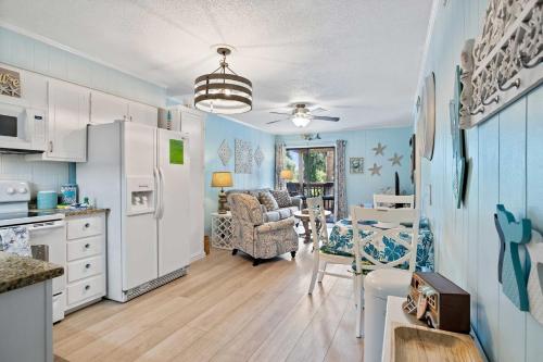 a kitchen and living room with a white refrigerator at Walk to Coligny Beach Park Family-Friendly Villa in Hilton Head Island