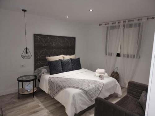 a bedroom with a large bed and a couch at ViLLA DREAMS JF in Arona