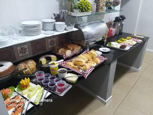 a buffet line with various food items on a table at Hotel Apiai in Apiaí