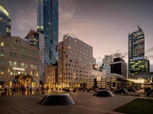 a city skyline with tall buildings in a city at The Hotel Britomart in Auckland