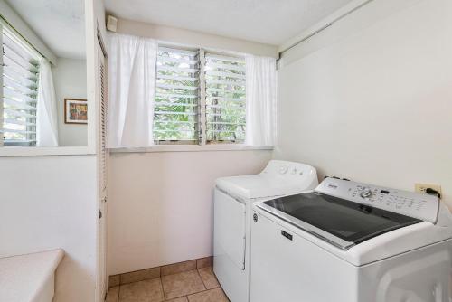a white washer and dryer in a room with a window at Hale Pahukoa in Kailua-Kona