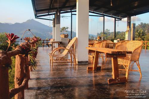 a patio with tables and chairs and a table and chairs at Square Peg in Kandy