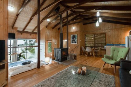 a living room with a couch and a fireplace at Treetops Seaview Montville in Montville